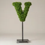 Monogram letter V topiary in Cinzel style, packed with green moss, on an adjustable stand