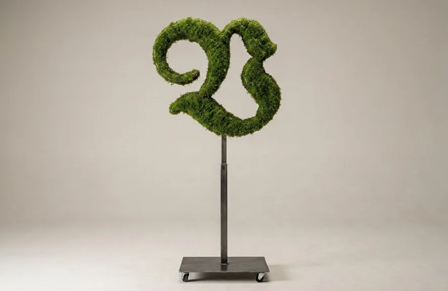 Monogram letter V topiary in Custom style, packed with green moss, on an adjustable stand