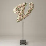 Monogram letter V topiary in script style, covered in pink and white roses