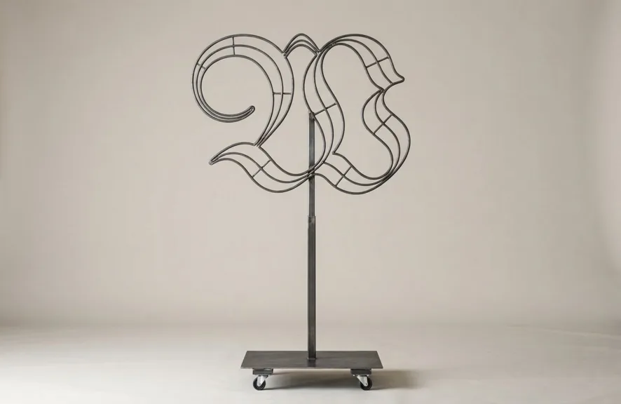 Monogram letter W topiary frame in Custom style, bare galvanized steel on an adjustable stand