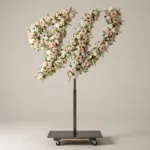 Monogram letter W topiary in script style, covered in pink and white roses