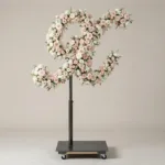 Monogram letter X topiary in script style, covered in pink and white roses