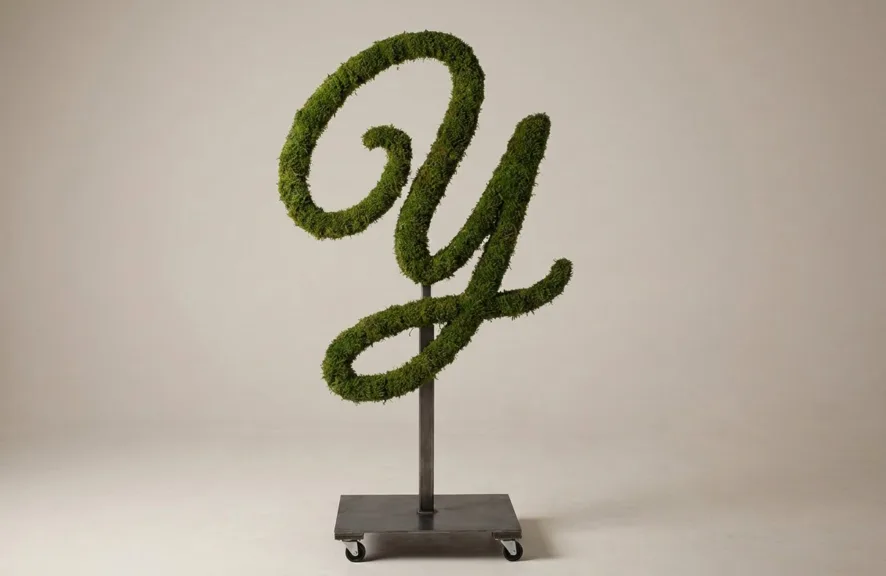 Monogram letter Y topiary in Flowing script style, packed with green moss, on an adjustable stand