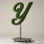 Monogram letter Y topiary in Script style, packed with green moss, on an adjustable stand