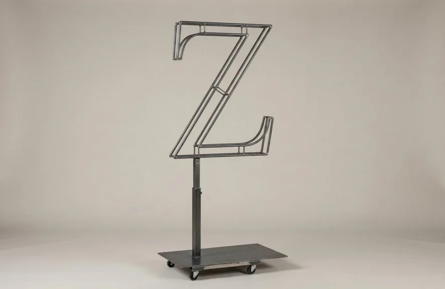 Monogram letter Z topiary frame in Cinzel style, bare galvanized steel on an adjustable stand