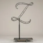 Monogram letter Z topiary frame in Flowing script style, bare galvanized steel on an adjustable stand