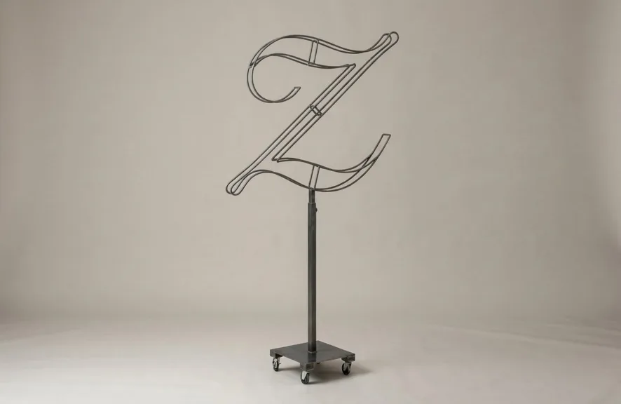 Monogram letter Z topiary frame in Script style, bare galvanized steel on an adjustable stand