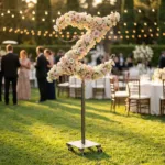 Monogram letter Z topiary covered in flowers as a photo backdrop at a garden wedding