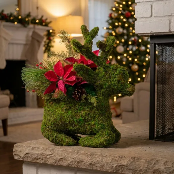 Moss reindeer planter on a fireplace hearth in a living room decorated for Christmas